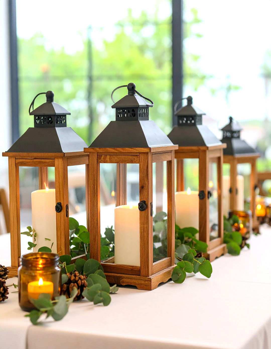 Rustic Wooden Lantern with Eucalyptus Garland - 24 Lantern Centerpiece Ideas